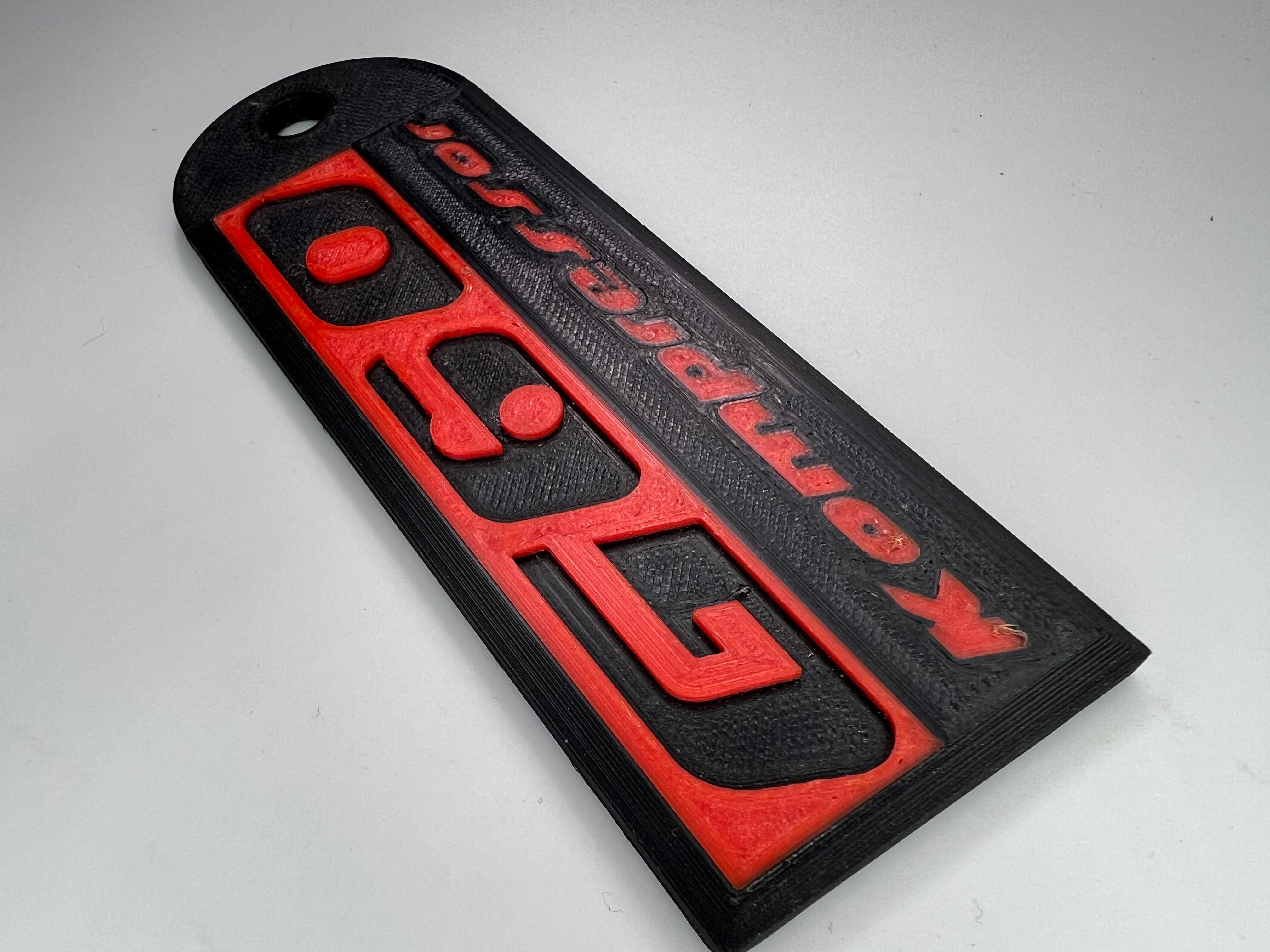 Emblem G60 Kompressor in der Farbe Rot und Schwarz aus Kunststoff